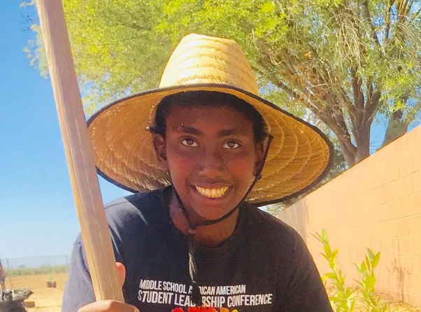 Yosef with straw sun hat and a big smile on his face!
